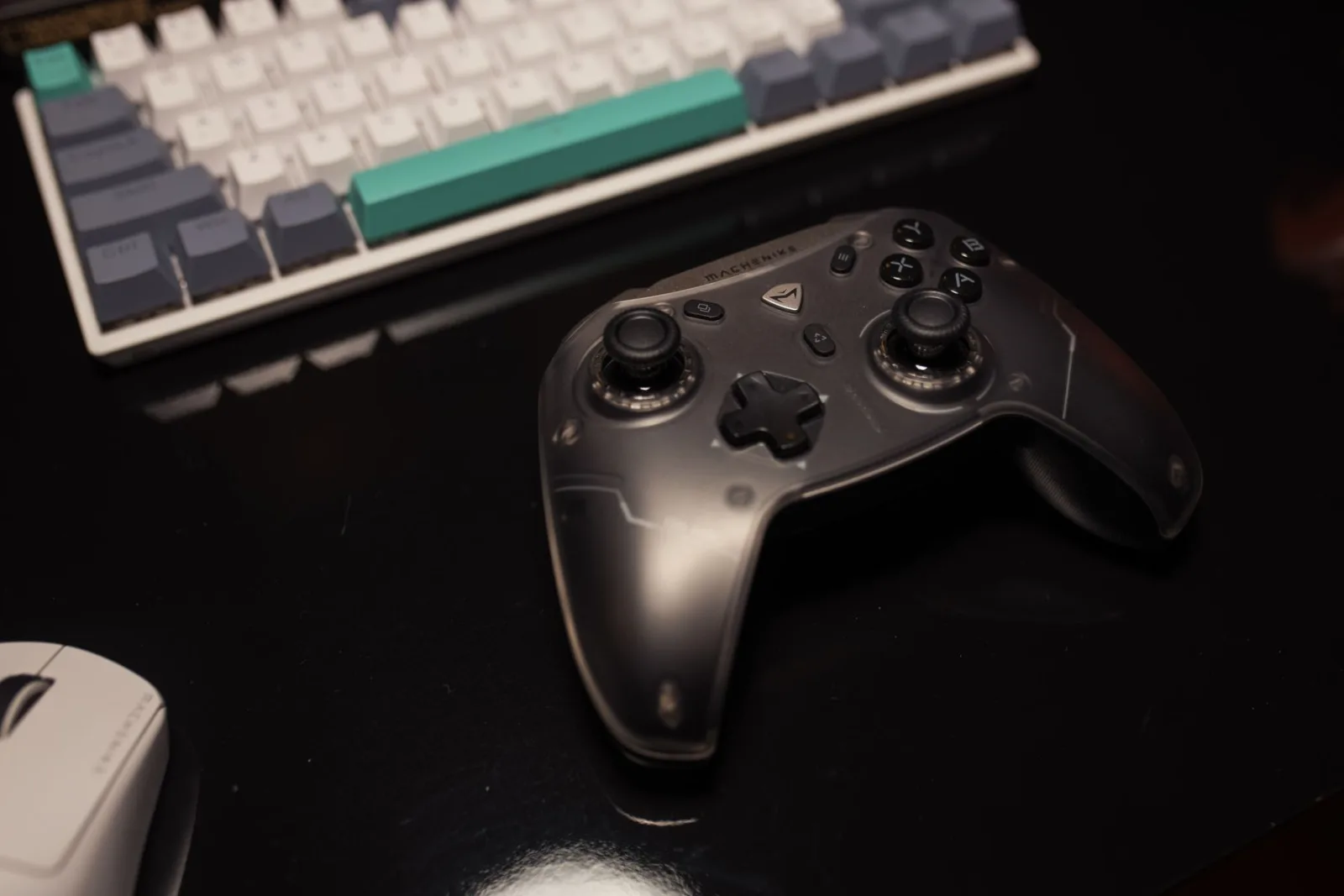 Gaming controller and keyboard at a dark desk
